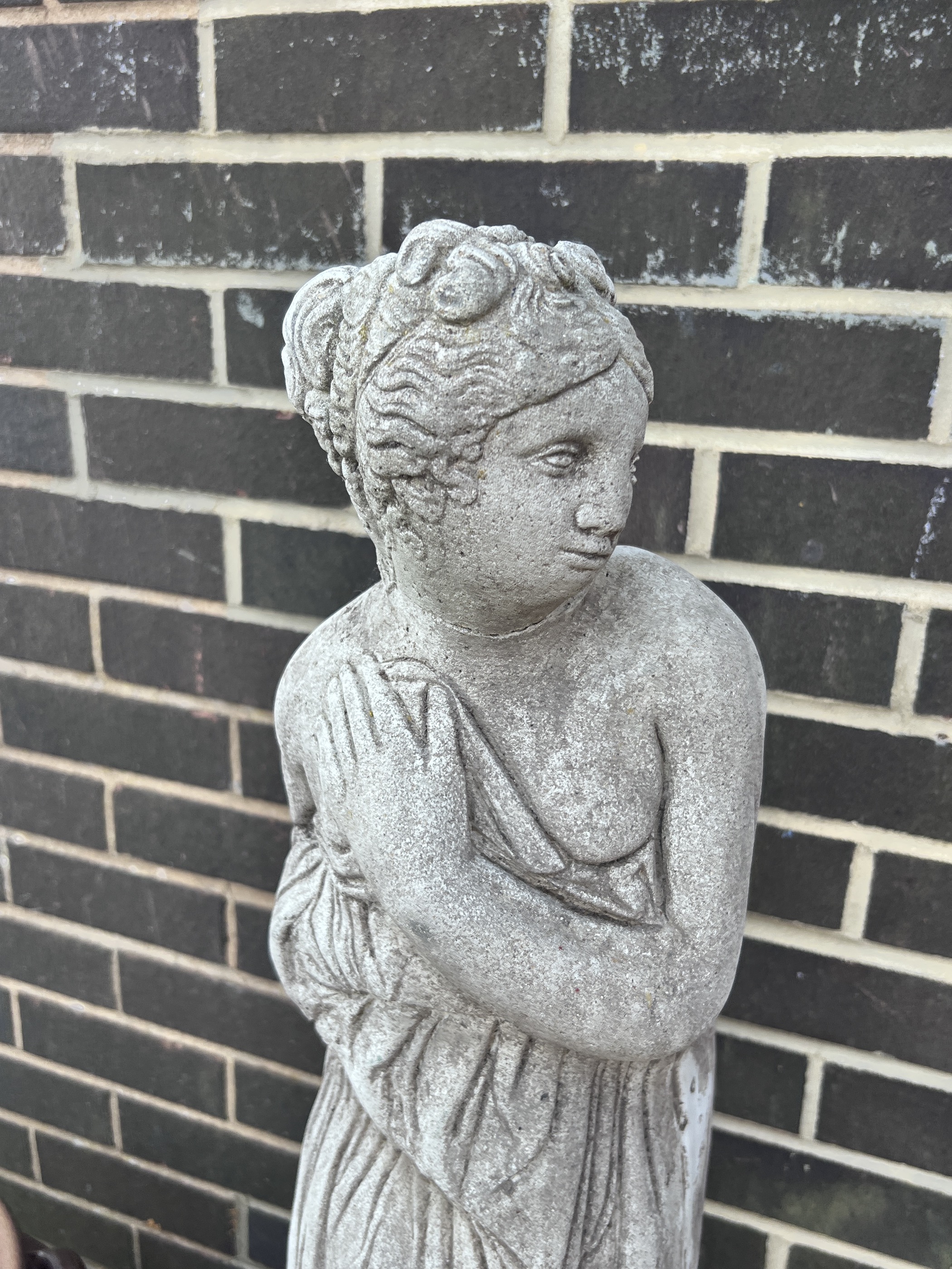 A reconstituted stone garden ornament of a robed lady, head detached, and a stone birdbath, tallest 120cm
